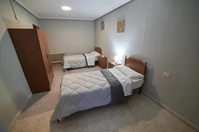 a small room with two beds in a room at Hostal Molgas in A Medorra