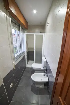 a bathroom with a white toilet and a sink at Hostal Molgas in A Medorra