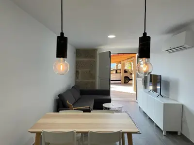 a living room with a table and a couch at Cepas Da Cuenga in Ribadavia