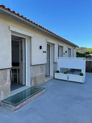 a patio with a pool in front of a house at Cepas Da Cuenga in Ribadavia