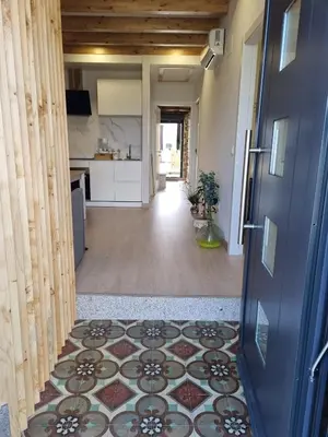 a hallway with a tile floor and a door at A CASIÑA DE ISABEL in Arzúa