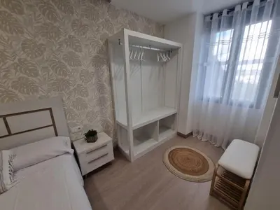 a bedroom with a bed and a dresser and a closet at A CASIÑA DE ISABEL in Arzúa