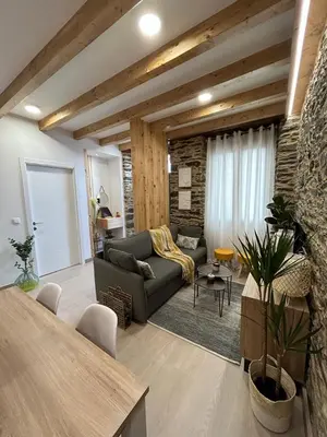 a living room with a couch and a table at A CASIÑA DE ISABEL in Arzúa