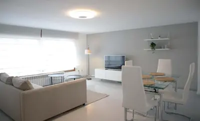 a living room with a couch and a table at Apartamento en Sigüeiro Rúa do Tambre in Sigüeiro