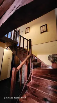 a wooden spiral staircase in a building with wooden floors at Apartamentos Rurales Casa Ardaliz in Cangas del Narcea