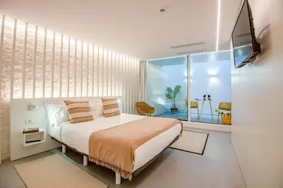a bedroom with a bed and a television in it at Apartamentos Atia Catedral in Santiago de Compostela
