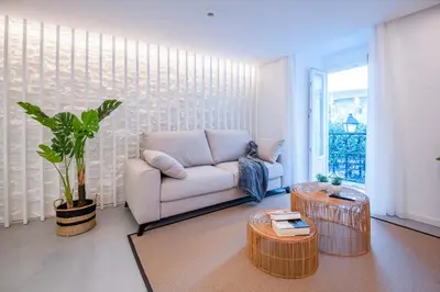 a living room with a couch and a table at Apartamentos Atia Catedral in Santiago de Compostela