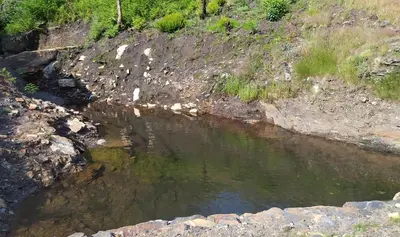 a small pool of water on a rocky hillside at O Busto Aldea Rural, Apartamento HORNO 1 in Puebla del Brollón