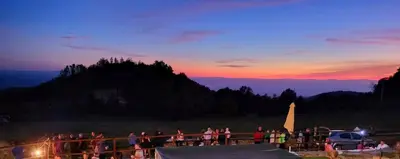 a group of people standing around watching the sunset at O Busto Aldea Rural, Apartamento HORNO 2 in A Pobra do Brollon
