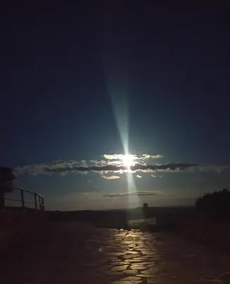 a sun shining in the sky over a body of water at O Busto Aldea Rural, Apartamento HORNO 2 in A Pobra do Brollon