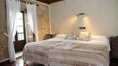 a bedroom with a bed and a window at Casa de Casal in Lestedo