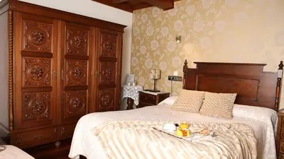 a bedroom with a large bed with a tray of food on it at Casa de Casal in Lestedo
