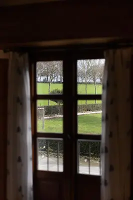 a view of a field from a window at Casa A Curiscada in Burres