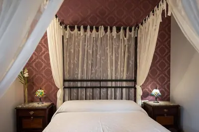 a bedroom with a bed and two night stands with lamps at Casa A Curiscada in Burres