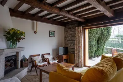 a living room with a couch and a fireplace at Casa A Curiscada in Burres