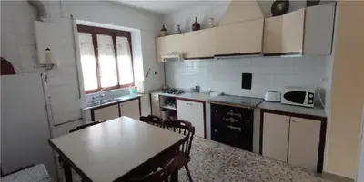 a small kitchen with a table and a table and a tableablish at Casa Ángel in Barreiros