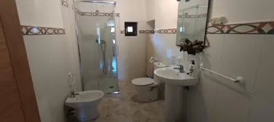 a bathroom with a shower and a sink and a toilet at Casa Ángel in Barreiros