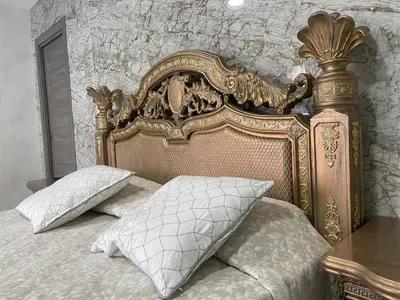 an ornate bed with two pillows in a bedroom at Luxury Barco de Valdeorras in Vegamolinos
