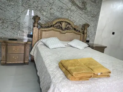 a bedroom with a bed with a golden blanket on it at Luxury Barco de Valdeorras in Vegamolinos