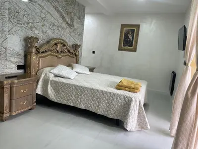 a bedroom with a bed with a wooden frame and a dresser at Luxury Barco de Valdeorras in Vegamolinos