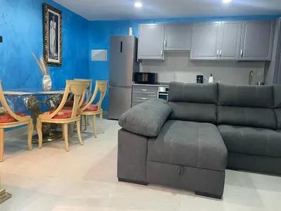 a living room with a couch and a kitchen at Luxury Barco de Valdeorras in Vegamolinos
