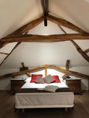 a bedroom with a white bed with red pillows at Hotel Villa México in Faramentaos