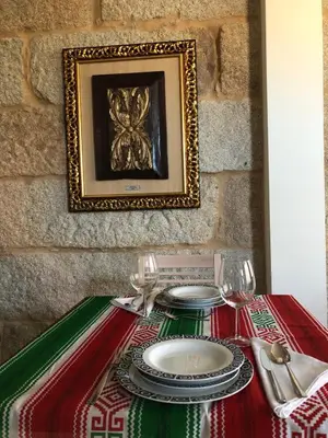 a table with a red and green table cloth with a plate at Hotel Villa México in Faramentaos