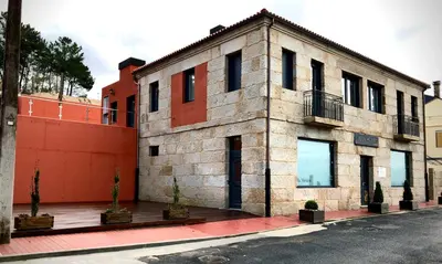 a large brick building with windows on a street at Hotel Villa México in Faramentaos
