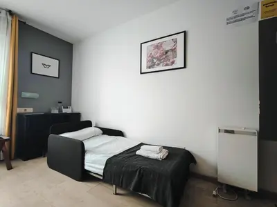 a bedroom with a bed and a white wall at Nest El Camino in Santiago de Compostela