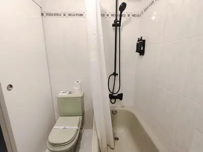 a bathroom with a toilet and a bath tub at Nest El Camino in Santiago de Compostela