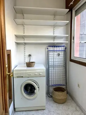 a laundry room with a washing machine and a washer at El apartamento de Ordes in Órdenes