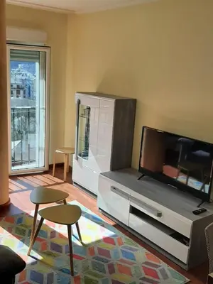 a living room with a flat screen tv and two chairs at Lazaro Sol in Viveiro