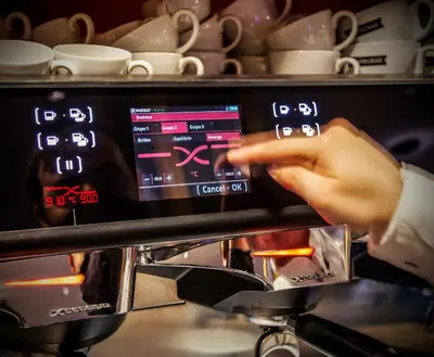 a person is adjusting the temperature of an oven at Blanco Hotel Spa in Navia