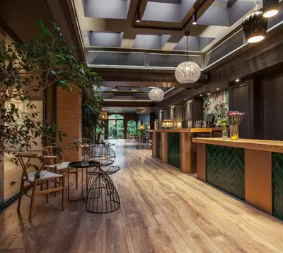 a lobby of a restaurant with tables and chairs at Blanco Hotel Spa in Navia