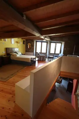 a large room with a bed and a living room at Casa Grande da Capellania in Padrón