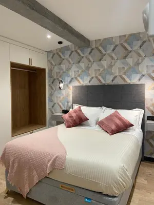 a bedroom with a large bed with red pillows at Siente Muralla in Lugo