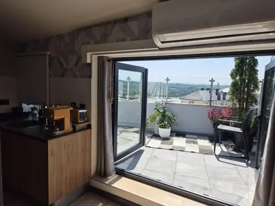 a kitchen with a view of a balcony with a window at Siente Muralla in Lugo