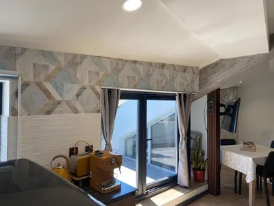 a room with a large window with a view of the ocean at Siente Muralla in Lugo