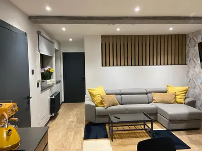 a living room with a gray couch and yellow pillows at Siente Muralla in Lugo