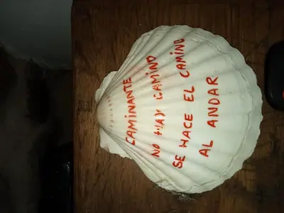 a white baseball glove with red writing on it at A Casiña da Ponte in Padrón