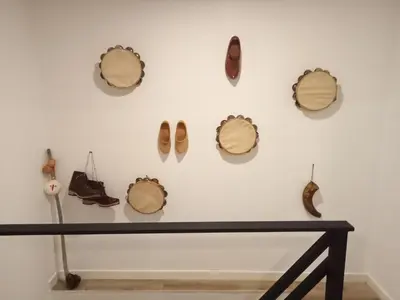 a wall with a bunch of hats and shoes on it at A Casiña da Ponte in Padrón