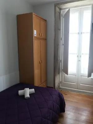 a bedroom with a bed with a white towel on it at PR Paz de Agra in Santiago de Compostela