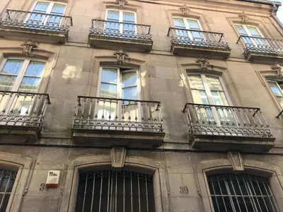 a building with balconies on the side of it at PR Paz de Agra in Santiago de Compostela
