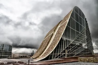 a large glass building with a curved roof at PR Paz de Agra in Santiago de Compostela