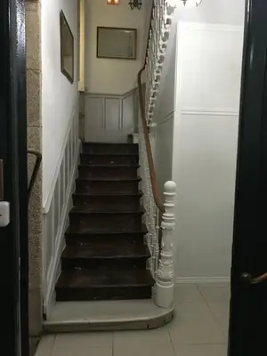 a stairway leading up to a room with white walls at PR Paz de Agra in Santiago de Compostela