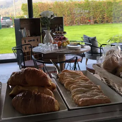 a table with several trays of bread and a table with a table with at Hotel Mi Norte in Ribadeo