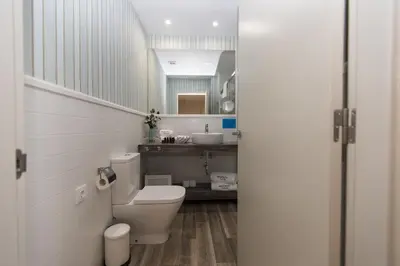 a bathroom with a toilet and a sink at Hotel Mi Norte in Ribadeo