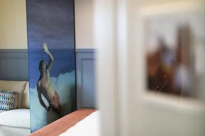 a room with a painting of a woman on the wall at Hotel Mi Norte in Ribadeo