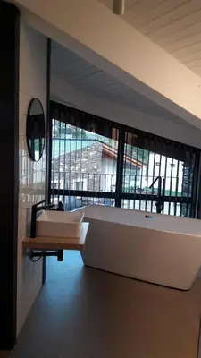 a large bath tub in a room with a large window at Hotel Rural O Cruce do Burgo in Friol