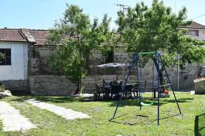 a playground in a yard with a swing set at Casa Avoa María in Ourense